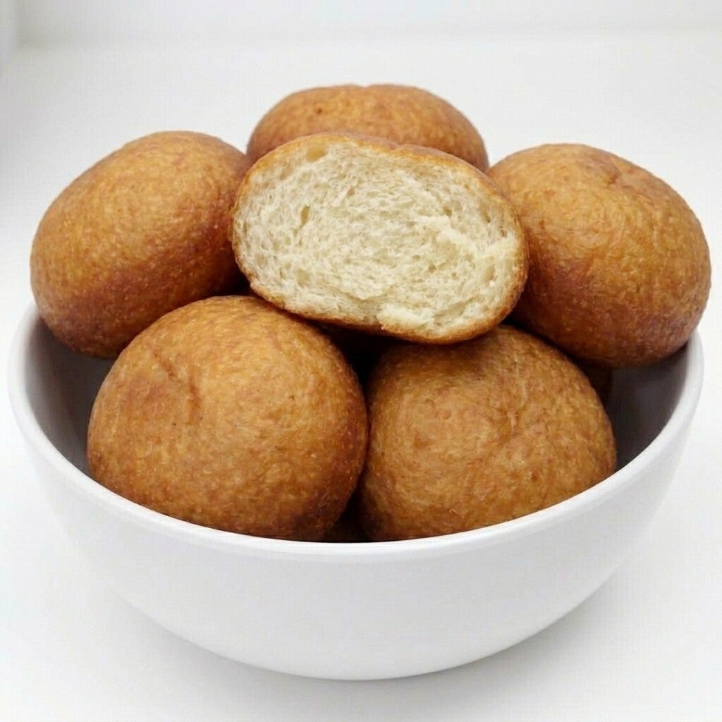 Fluffy golden Nigerian puff puff dough balls on a plate